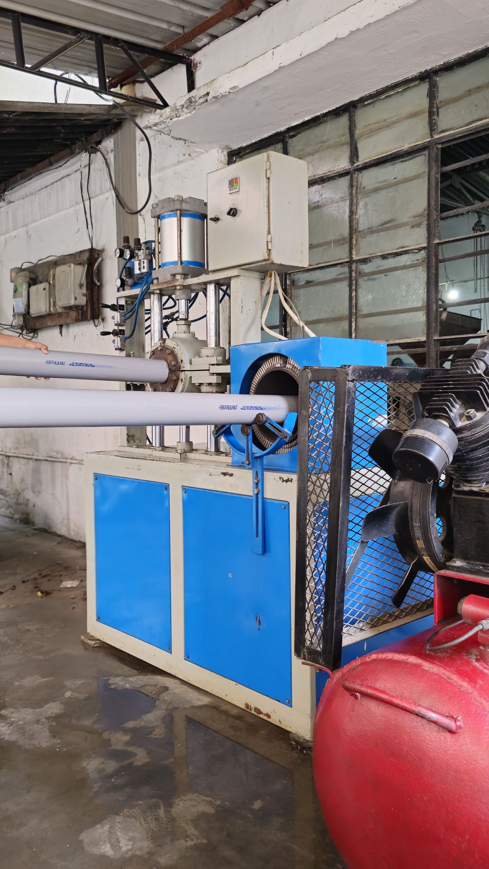 Freshly extruded Perfit PVC pipes on the production line